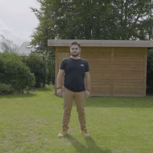 Man In Black SBS T-Shirt By Wooden Shed GIF