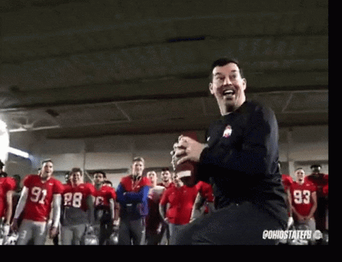 Man in Black Shirt 93 Dancing in Front of Football Players