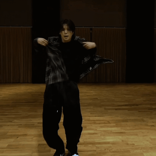 Man in Black Shirt and Black Pants on Wooden Floor