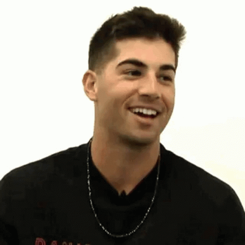 Man in Black Shirt and Chain Smiling