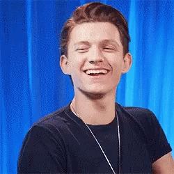 Man In Black Shirt And Necklace Smiling GIF