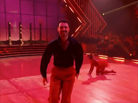 Man in Black Shirt and Red Pants Dancing on Stage