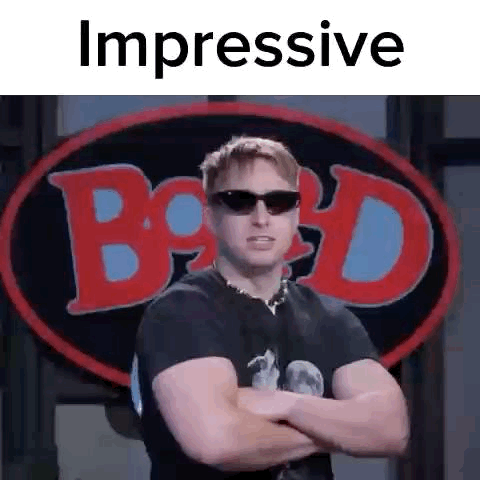 Man in Black Shirt and Sunglasses Arms Crossed at Billboard