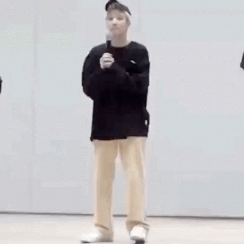 Man in Black Shirt and Tan Pants