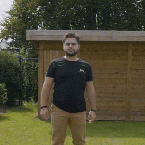 Man In Black Shirt And Tan Pants GIF