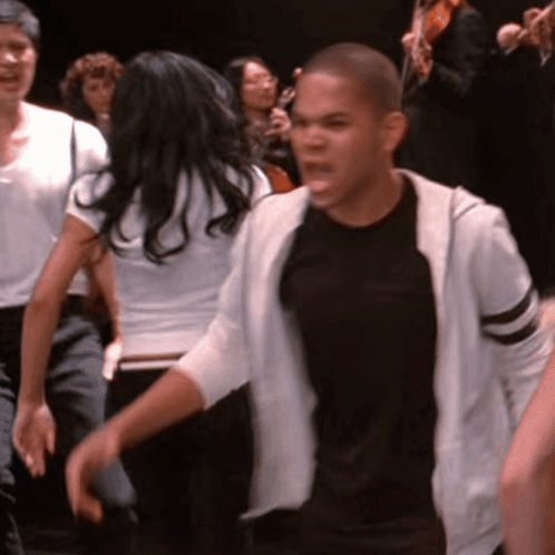 Man in Black Shirt and White Hoodie in Crowd