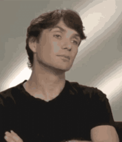 Man in Black Shirt Arms Crossed Looking at Camera