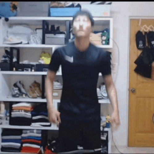 Man In Black Shirt Before Closet Full Of Clothes And Shoes GIF