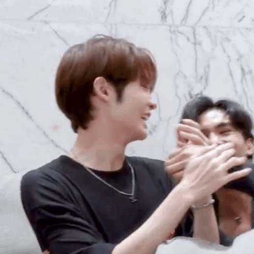Man in Black Shirt Clapping While Another Man Watches