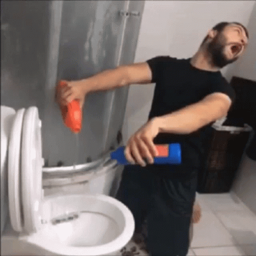 Man in Black Shirt Cleaning Toilet