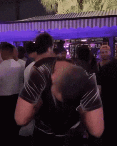 Man in Black Shirt Dancing in Crowd at Party
