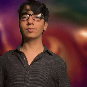 Man in Black Shirt Dancing With Arms Outstretched in Front of Colorful Background