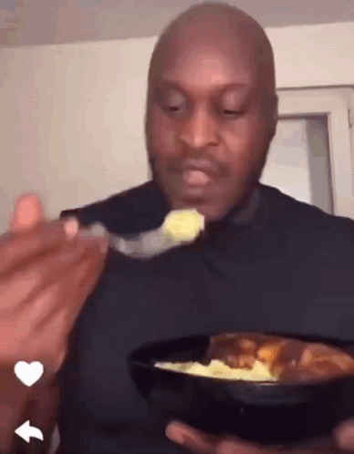 Man in Black Shirt Eating Food
