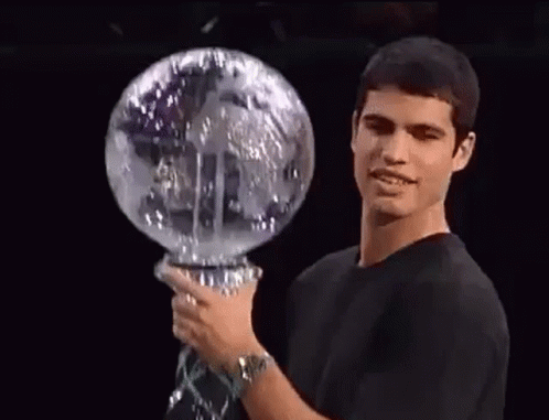 Man in Black Shirt Holding Glass Globe