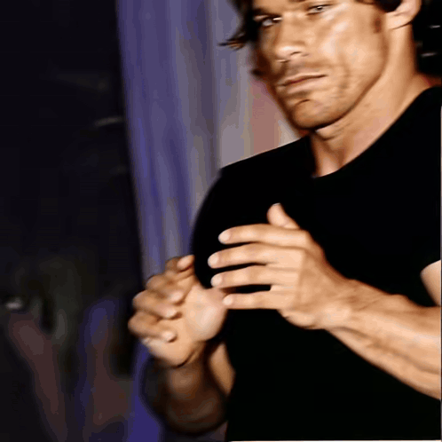 Man in Black Shirt Holding Hands Together