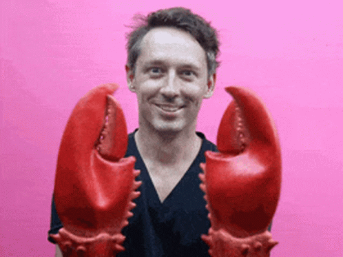 Man in Black Shirt Holding Lobster Claws