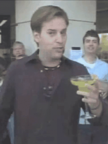 Man in Black Shirt Holding Martini
