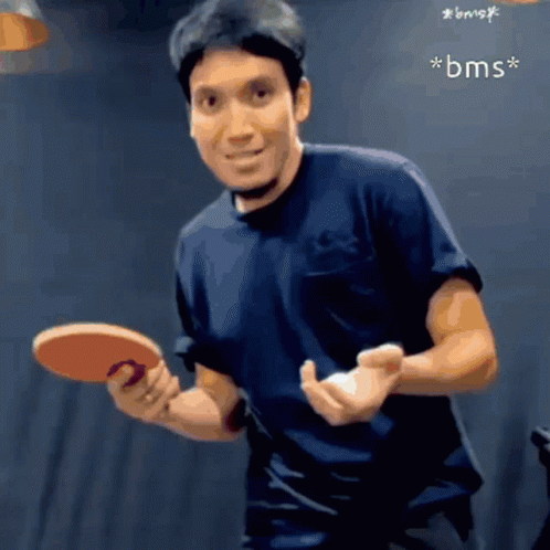 Man in Black Shirt Holding Ping Pong Paddle