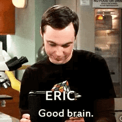 Man in Black Shirt Holding Tablet Says Eric Good Brain