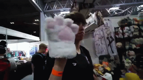 Man in Black Shirt Holding White Paw Glove