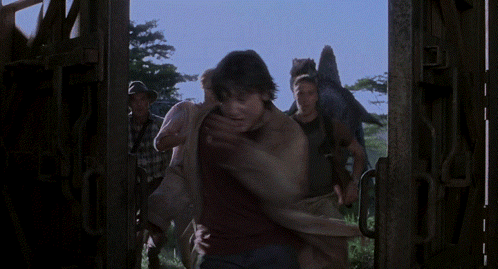 Man In Black Shirt Holding Woman In Purple Shirt GIF