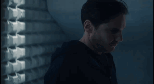 Man in Black Shirt in Dark Room