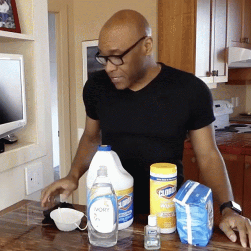 Man In Black Shirt In Front Of Clorox Bottle GIF