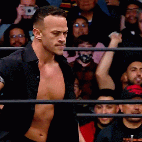 Man In Black Shirt In Front Of Crowd GIF