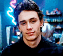 Man In Black Shirt In Front Of Neon Sign GIF
