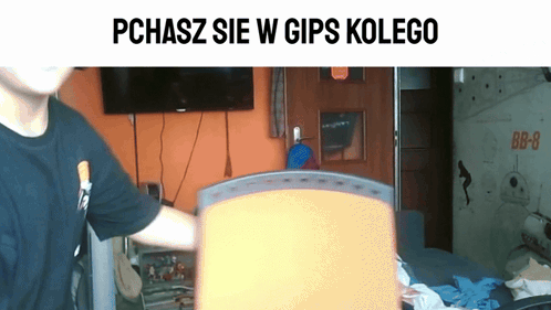 Man In Black Shirt In Front Of TV Saying Pchasz Sie W Gips Kolego GIF