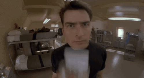 Man In Black Shirt Looking At Camera GIF
