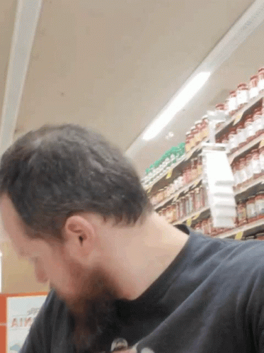 Man in Black Shirt Looking Down