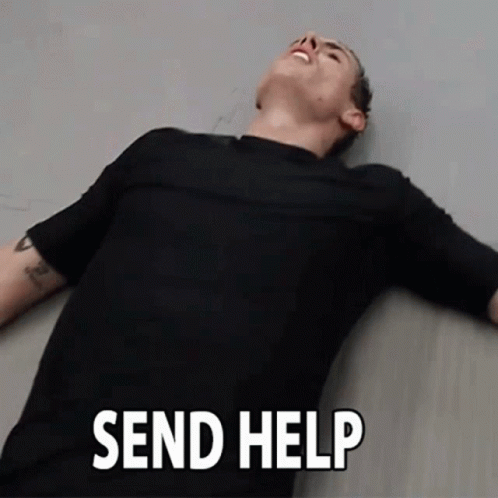 Man in Black Shirt Lying on Floor Send Help