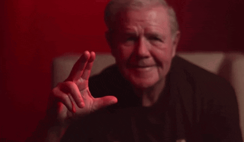 Man in Black Shirt Making Gesture on Couch