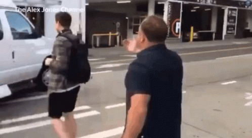 Man in Black Shirt Next to White Van