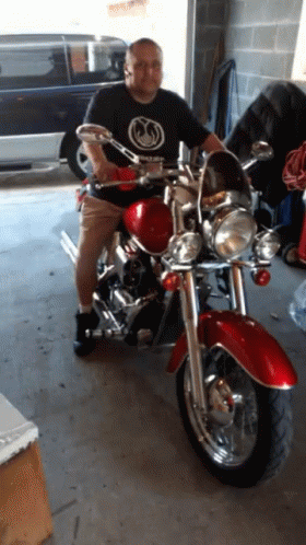 Man in Black Shirt on Red Motorcycle
