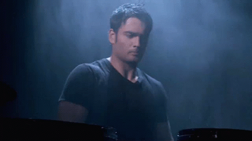 Man in Black Shirt Playing Drum Set