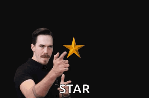 Man In Black Shirt Pointing At Gold Stars With Star GIF