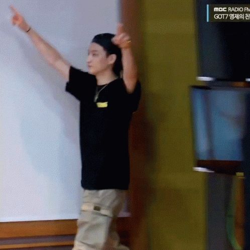 Man In Black Shirt Pointing At MBC Radio FM Sign GIF