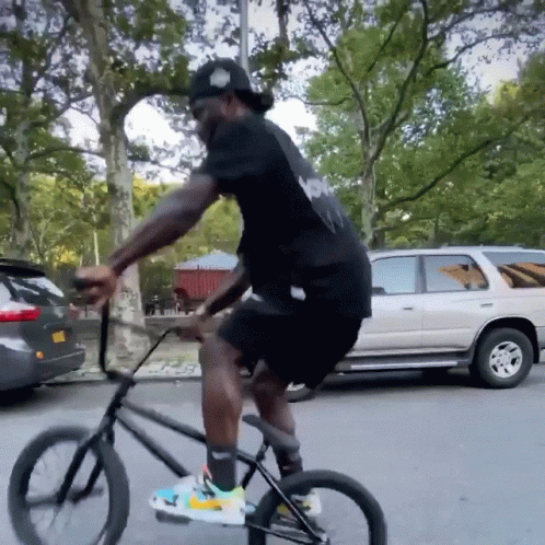 Man in Black Shirt Riding Bike