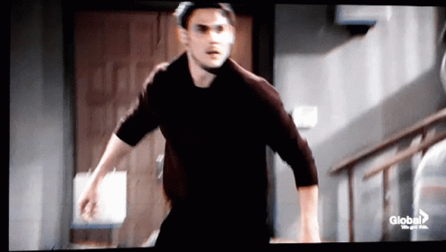 Man In Black Shirt Running Down Stairs GIF