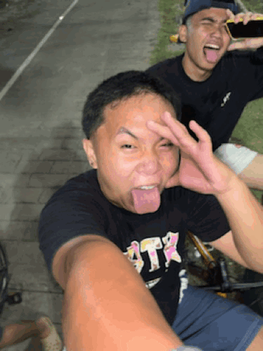 Man in Black Shirt Saying ATR Sticking Tongue Out