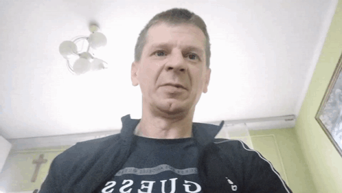 Man In Black Shirt Saying Guess GIF