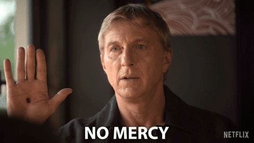 Man In Black Shirt Says No Mercy GIF
