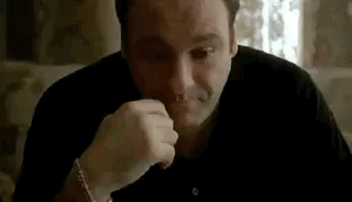 Man In Black Shirt Sitting At Table GIF