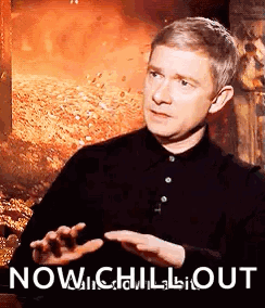 Man in Black Shirt Sitting by Fire Saying Now Chill Out