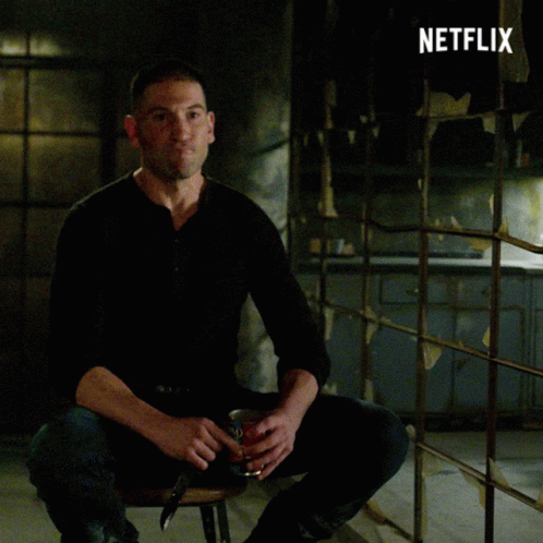 Man in Black Shirt Sitting in Front of Netflix