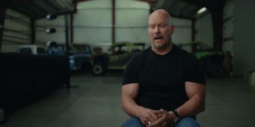 Man in Black Shirt Sitting in Garage