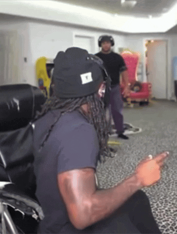 Man in Black Shirt Sitting in Red and Black Chair Justfanum