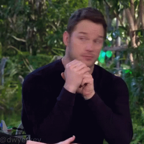 Man in Black Shirt Sitting with Folded Hands